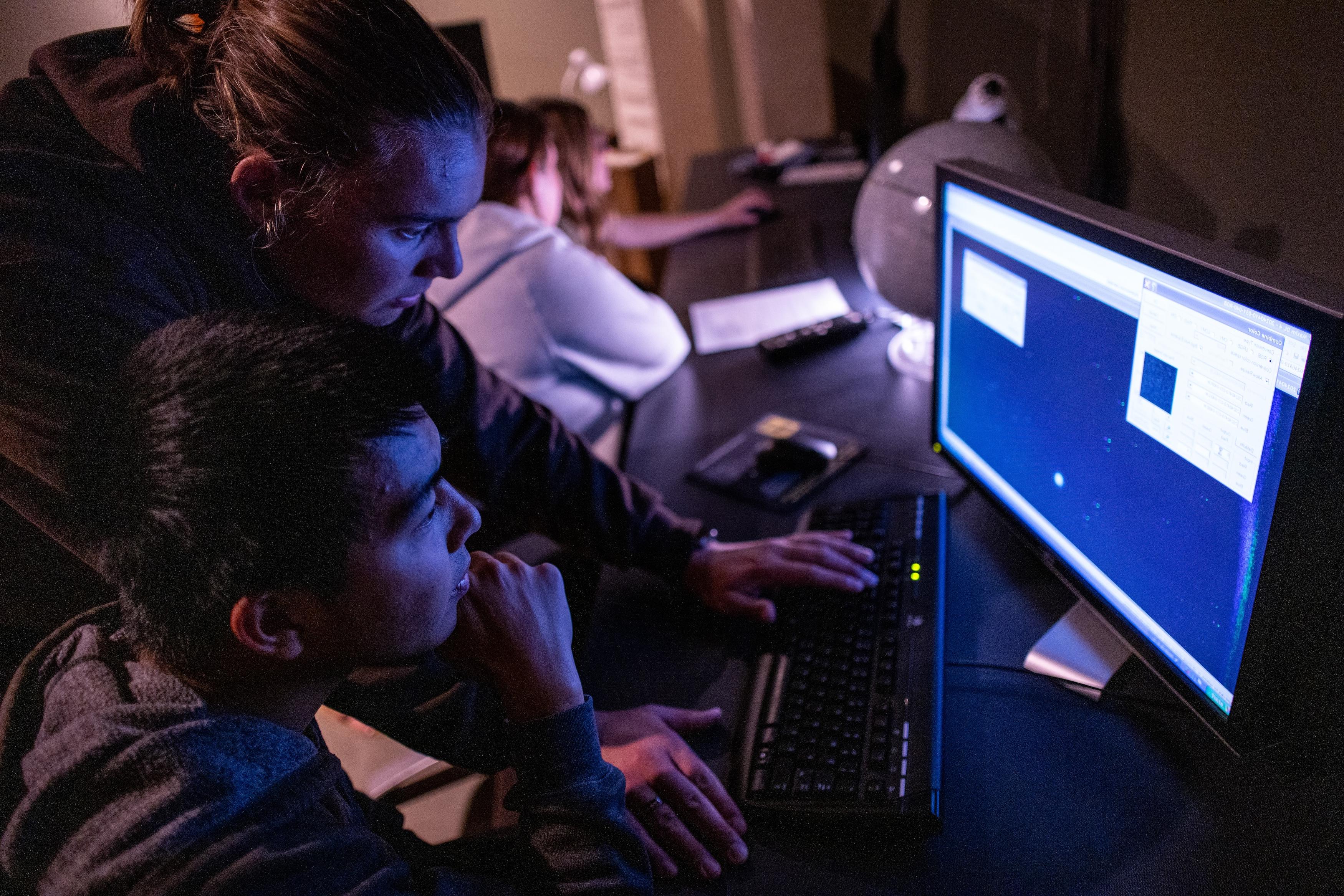 students looking at data on computer